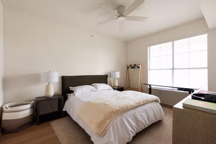 Full bedroom with ceiling fan and large window