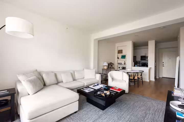 Open living and dining plan showing full kitchen flow