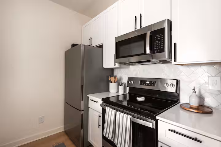 Marble tile shower with glass door and black hardware